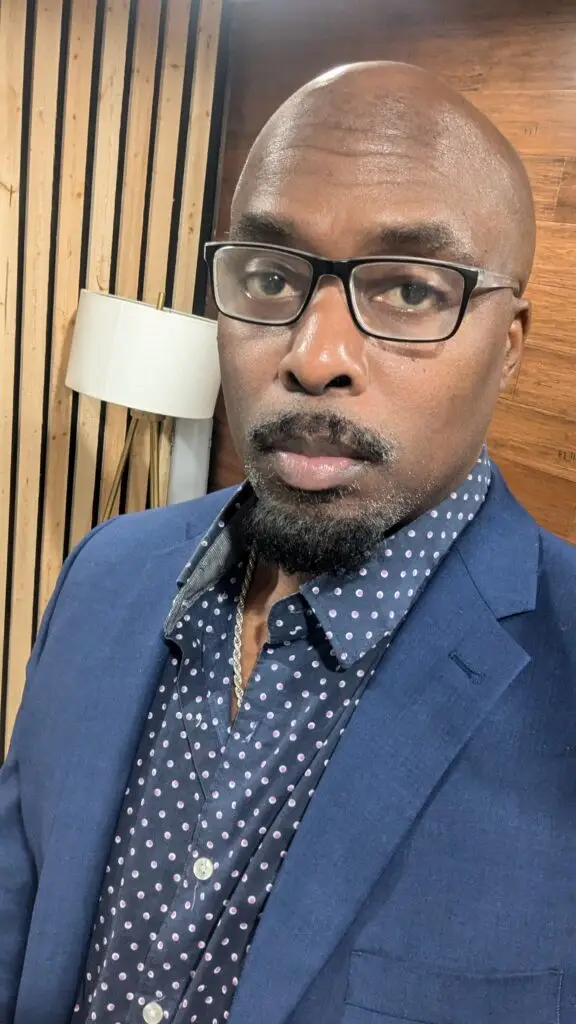 Headshot of Edward Newbins in a blue suit.